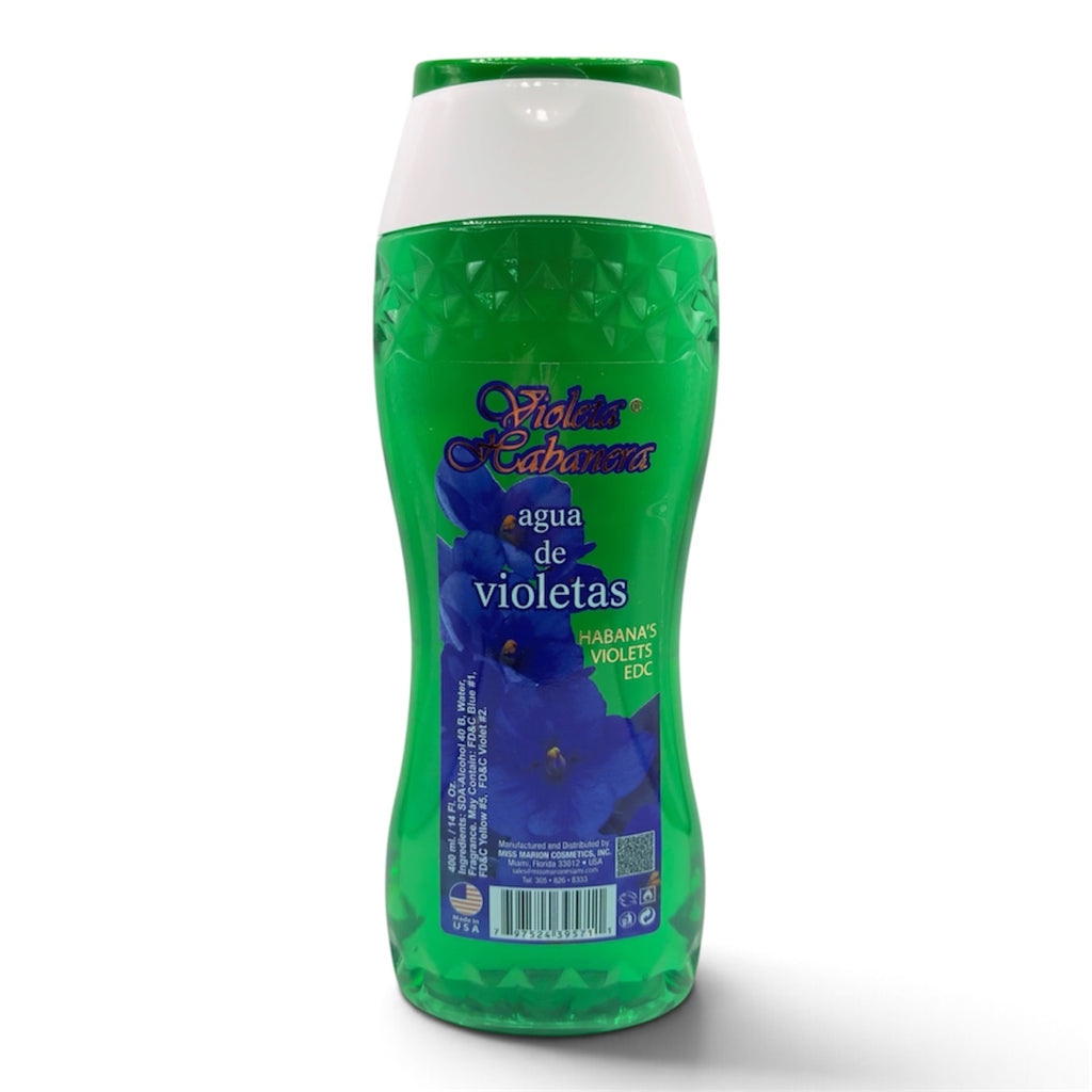 A bottle of Fiebre Verda 'Agua de violetas' (Violettes) hand wash, featuring a green textured bottle with a white cap and a blue-purple violet graphic on the label.